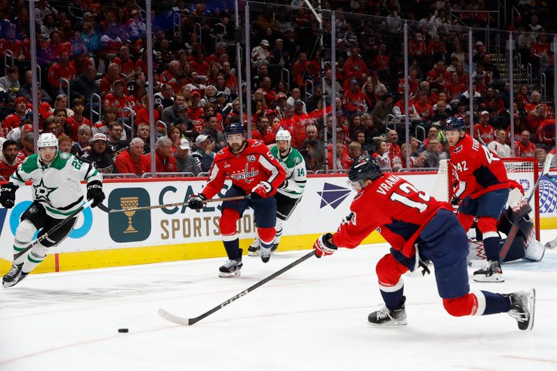 Oct 17, 2024; Washington, District of Columbia, USA; Washington Capitals left wing Jakub Vrana (13) reaches for the puck in front of Dallas Stars center Mavrik Bourque (22) in the second period at Capital One Arena. Mandatory Credit: Geoff Burke-Imagn Images