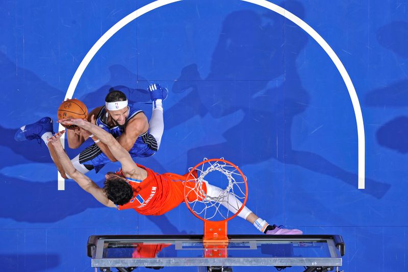 ORLANDO, FL - FEBRUARY 13: Jalen Suggs #4 of the Orlando Magic shoots the ball during the game against the Oklahoma City Thunder  on February 13, 2024 at the Kia Center in Orlando, Florida. NOTE TO USER: User expressly acknowledges and agrees that, by downloading and or using this photograph, User is consenting to the terms and conditions of the Getty Images License Agreement. Mandatory Copyright Notice: Copyright 2024 NBAE (Photo by Fernando Medina/NBAE via Getty Images)