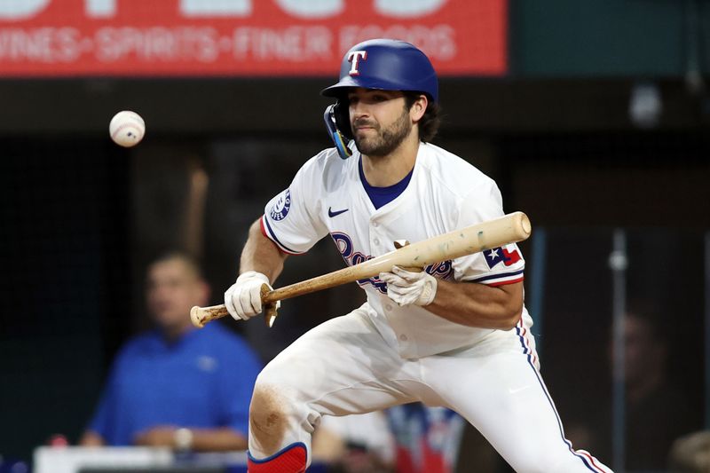 Jun 22, 2024; Arlington, Texas, USA; Texas Rangers third base Josh Smith (8) makes a sacrifice bunt in the eighth inning against the Kansas City Royals at Globe Life Field. Mandatory Credit: Tim Heitman-USA TODAY Sports