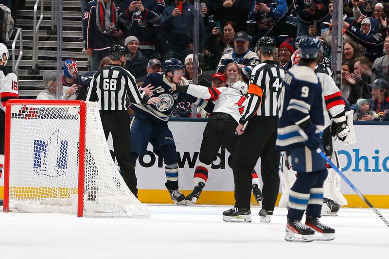 Dec 31, 2025; Columbus, Ohio, USA; Columbus Blue Jackets left wing Dmitri Voronkov (10) and New Jersey Devils center Cody Glass (12) fight during the third period at Nationwide Arena. Mandatory Credit: Russell LaBounty-Imagn Images