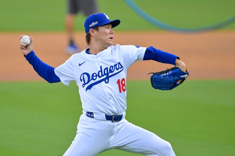 Oct 5, 2024; Los Angeles, California, USA; Los Angeles pitcher Yoshinobu Yamamoto (18) warms up before playing against the San Diego Padres in game one of the NLDS for the 2024 MLB Playoffs at Dodger Stadium. Mandatory Credit: Jayne Kamin-Oncea-Imagn Images