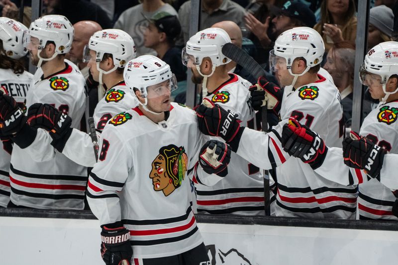 Nov 14, 2024; Seattle, Washington, USA;  Chicago Blackhawks forward Ryan Donato (8) is congratulated by teammates on the bench after scoring a goal during the third period against the Seattle Kraken at Climate Pledge Arena. Mandatory Credit: Stephen Brashear-Imagn Images