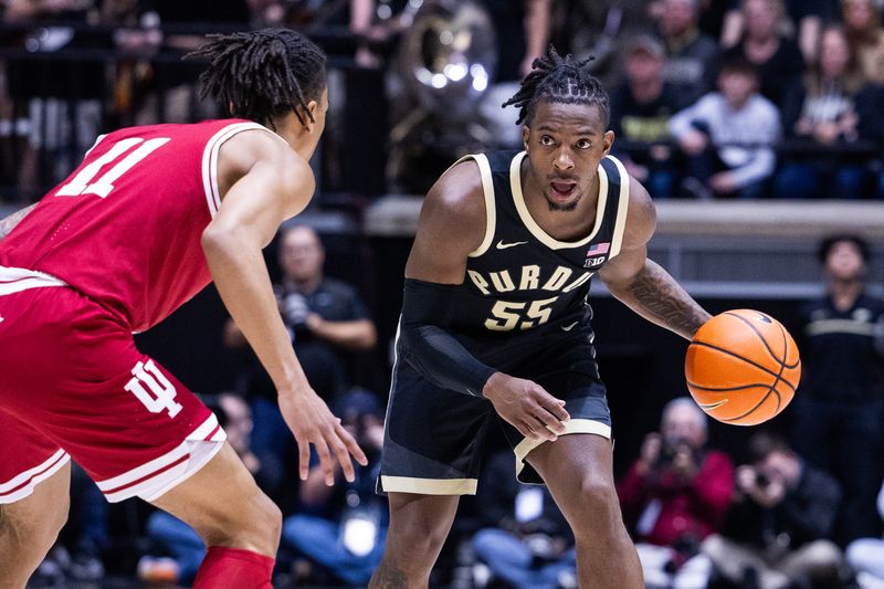 Feb 10, 2024; West Lafayette, Indiana, USA; Purdue Boilermakers guard Lance Jones (55) dribbles the ball while Indiana Hoosiers guard CJ Gunn (11) defends in the second half at Mackey Arena. Mandatory Credit: Trevor Ruszkowski-USA TODAY Sports