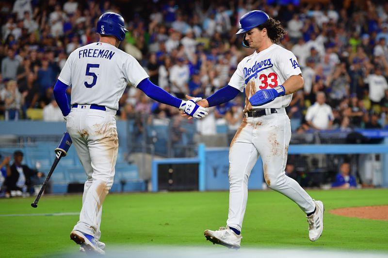 Aug 15, 2023; Los Angeles, California, USA; Los Angeles Dodgers center fielder James Outman (33) is greeted by first baseman Freddie Freeman (5) after scoring a run against the Milwaukee Brewers during the sixth inning at Dodger Stadium. Mandatory Credit: Gary A. Vasquez-USA TODAY Sports