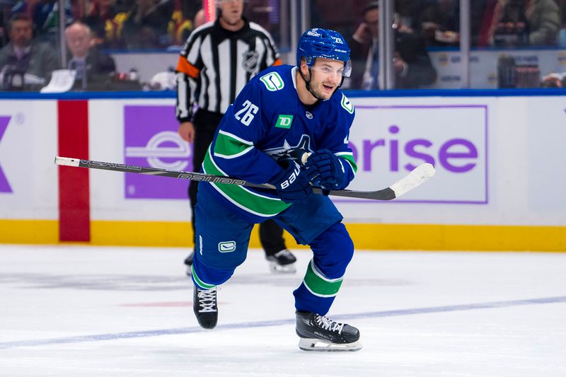 Nov 17, 2024; Vancouver, British Columbia, CAN; Vancouver Canucks defenseman Erik Brannstrom (26) celebrates his goal against the Nashville Predators during the first period at Rogers Arena. Mandatory Credit: Bob Frid-Imagn Images