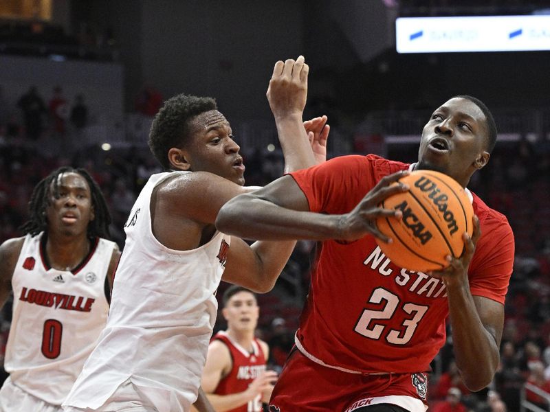 Jan 13, 2024; Louisville, Kentucky, USA;  North Carolina State Wolfpack forward Mohamed Diarra (23) controls the ball against Louisville Cardinals guard Curtis Williams (1) during the first half at KFC Yum! Center. Mandatory Credit: Jamie Rhodes-USA TODAY Sports