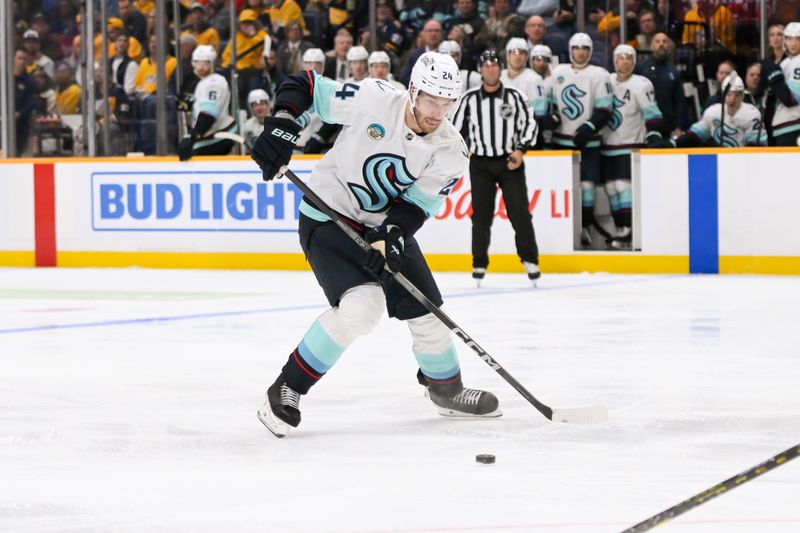 Oct 15, 2024; Nashville, Tennessee, USA;  Seattle Kraken defenseman Jamie Oleksiak (24) skates with the puck against the Nashville Predators during the second period at Bridgestone Arena. Mandatory Credit: Steve Roberts-Imagn Images