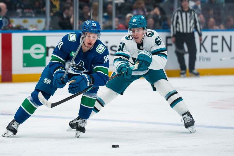 Dec 27, 2025; Vancouver, British Columbia, CAN; San Jose Sharks forward Collin Graf (51) stick checks Vancouver Canucks forward Marco Rossi (93) in the second period at Rogers Arena. Mandatory Credit: Bob Frid-Imagn Images