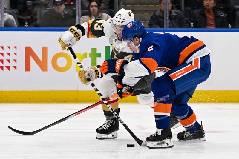 Jan 23, 2024; Elmont, New York, USA;  New York Islanders defenseman Mike Reilly (2) defends against Vegas Golden Knights center Paul Cotter (43) during the third period at UBS Arena. Mandatory Credit: Dennis Schneidler-USA TODAY Sports