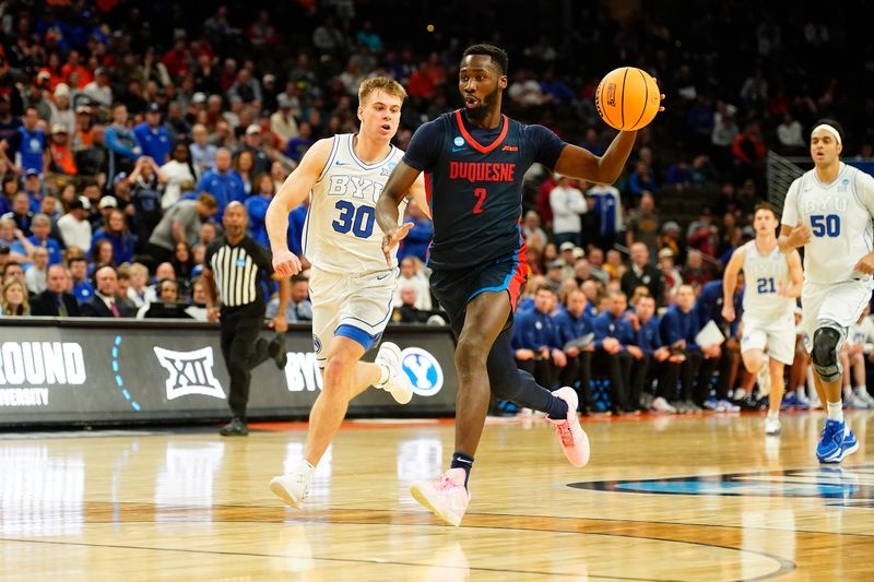 Mar 21, 2024; Omaha, NE, USA; Duquesne Dukes forward David Dixon (2) drives past Brigham Young Cougars guard Dallin Hall (30) in the second half  in the first round of the 2024 NCAA Tournament at CHI Health Center Omaha. Mandatory Credit: Dylan Widger-USA TODAY Sports