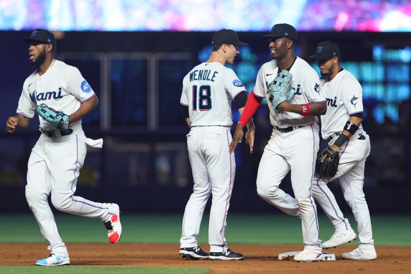 Aug 27, 2023; Miami, Florida, USA; Miami Marlins right fielder Jesus Sanchez (7) celebrates with shortstop Joey Wendle (18) after winning the game against the Washington Nationals at loanDepot Park. Mandatory Credit: Sam Navarro-USA TODAY Sports