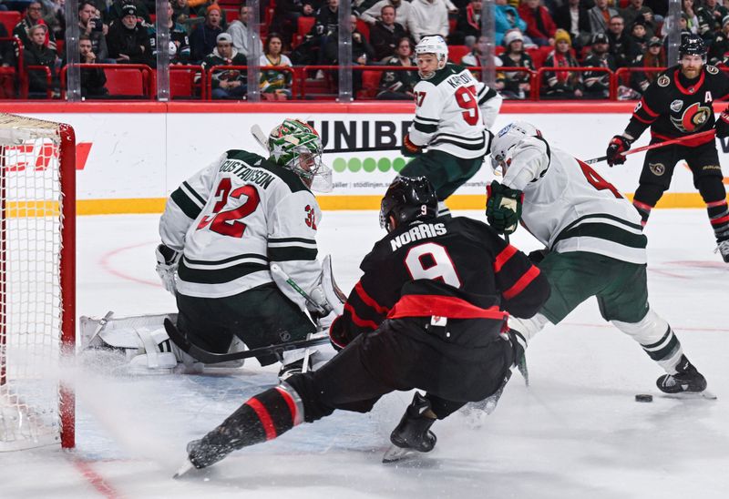 Nov 18, 2023; Stockholm, SWE; Minnesota Wild goaltender Filip Gustavsson (32) defends the net as Ottawa Senators center Josh Norris (9) looks for the puck during a Global Series NHL hockey game at Avicii Arena. Mandatory Credit: Per Haljestam-USA TODAY Sports