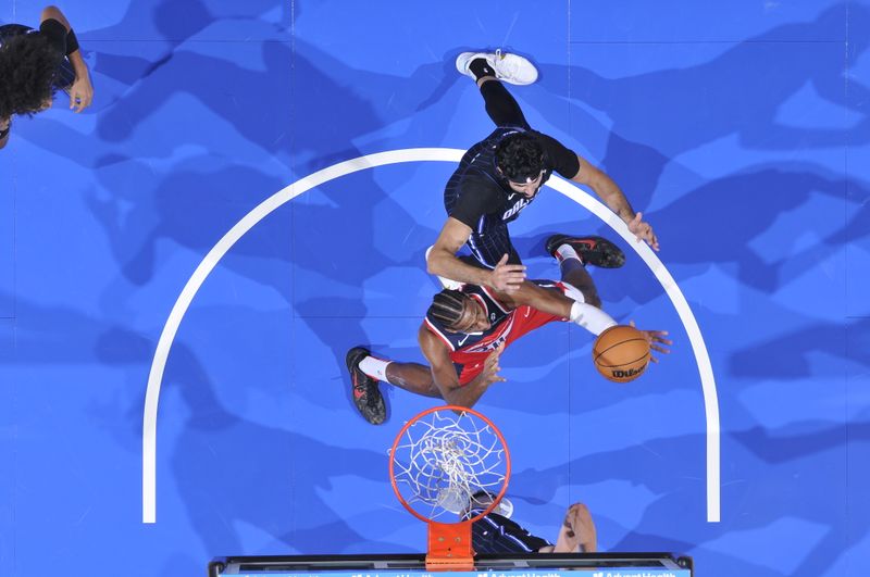 ORLANDO, FL - NOVMEBER 10: Alexandre Sarr #20 of the Washington Wizards goes up for the rebound during the game against the Orlando Magic on November 10, 2024 at Kia Center in Orlando, Florida. NOTE TO USER: User expressly acknowledges and agrees that, by downloading and or using this photograph, User is consenting to the terms and conditions of the Getty Images License Agreement. Mandatory Copyright Notice: Copyright 2024 NBAE (Photo by Fernando Medina/NBAE via Getty Images)