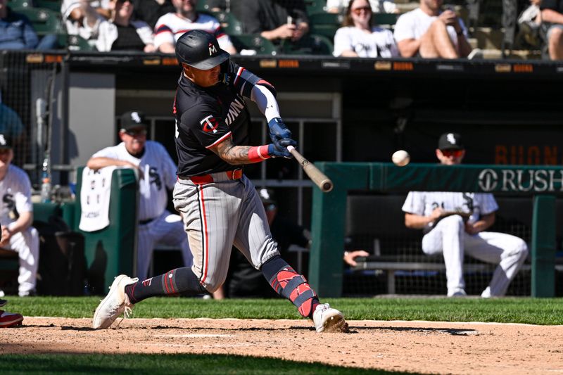 May 1, 2024; Chicago, Illinois, USA; Minnesota Twins third base Jose Miranda (64) hits an RBI double against the Chicago White Sox during the ninth inning at Guaranteed Rate Field. Mandatory Credit: Matt Marton-USA TODAY Sports