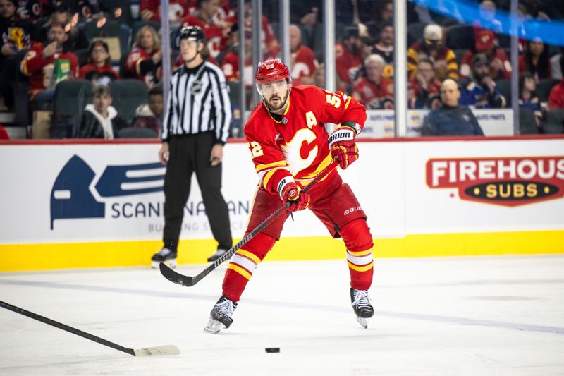 Dec 5, 2024; Calgary, Alberta, CAN; Calgary Flames defenseman MacKenzie Weegar (52) passes the puck during the second period against the St. Louis Blues at Scotiabank Saddledome. Mandatory Credit: Brett Holmes-Imagn Images