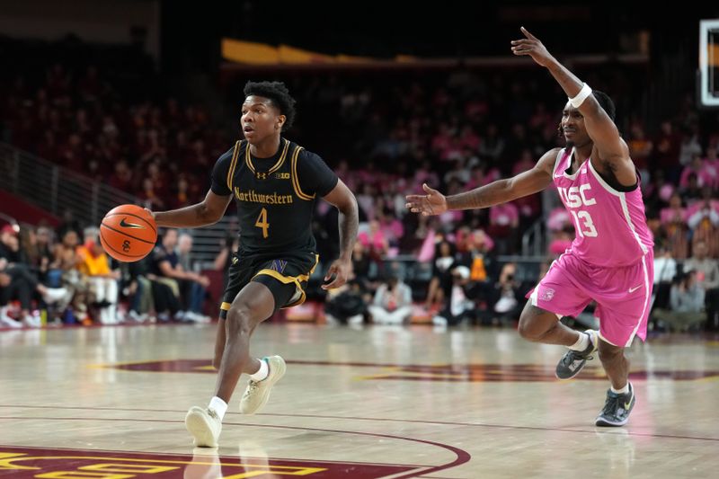 Jan 21, 2026; Los Angeles, California, USA; Northwestern Wildcats guard Jayden Reid (4) dribbles the ball against Southern California Trojans guard Kam Woods (13) in the first half at Galen Center. Mandatory Credit: Kirby Lee-Imagn Images