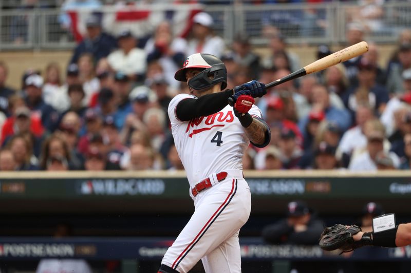 Oct 4, 2023; Minneapolis, Minnesota, USA; Minnesota Twins shortstop Carlos Correa (4) hits a single in the in the second inning against the Toronto Blue Jays during game two of the Wildcard series for the 2023 MLB playoffs at Target Field. Mandatory Credit: Jesse Johnson-USA TODAY Sports