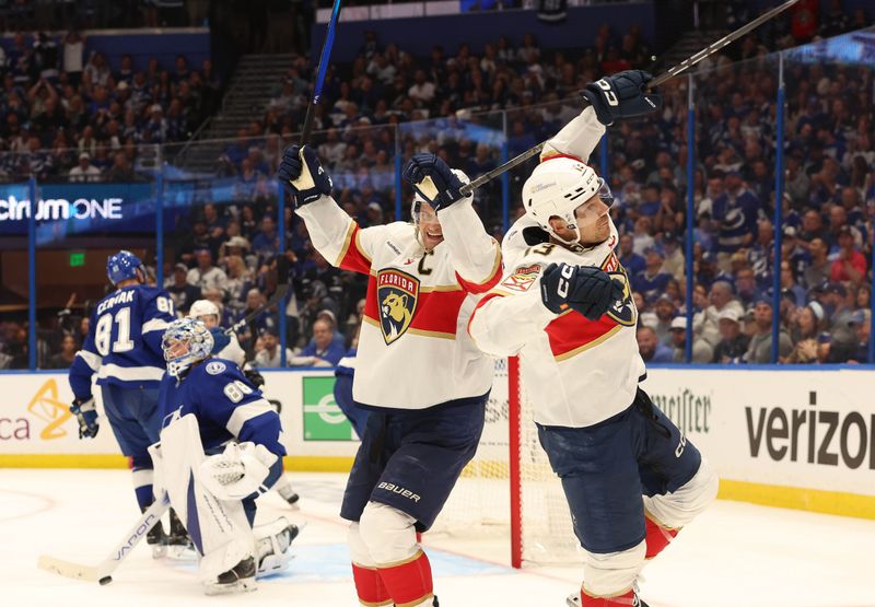 Apr 25, 2024; Tampa, Florida, USA; Florida Panthers center Sam Reinhart (13) is congratulated by left wing Matthew Tkachuk (19) after scoring against the Tampa Bay Lightning  during the second period in game three of the first round of the 2024 Stanley Cup Playoffs at Amalie Arena. Mandatory Credit: Kim Klement Neitzel-USA TODAY Sports