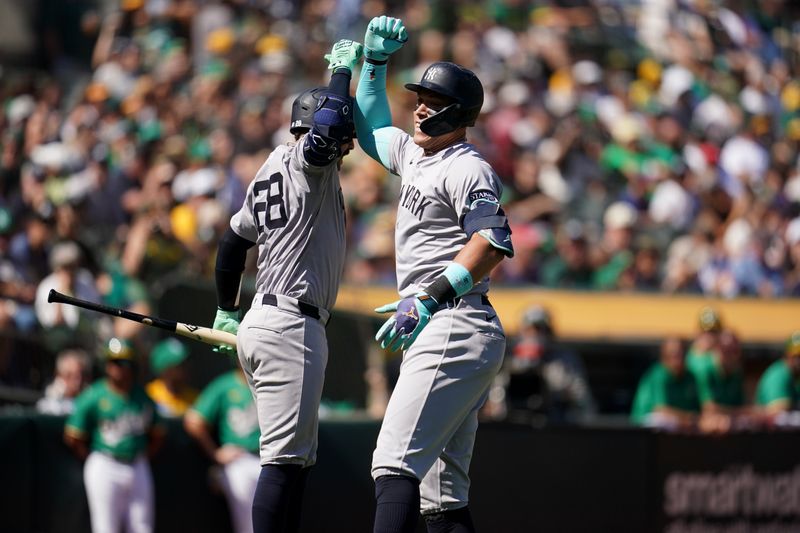Sep 22, 2024; Oakland, California, USA; New York Yankees center fielder Aaron Judge (99) celebrates with catcher Austin Wells (28) after hitting a home run against the Oakland Athletics in the third inning at the Oakland-Alameda County Coliseum. Mandatory Credit: Cary Edmondson-Imagn Images