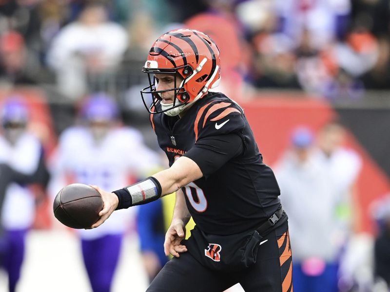 Cincinnati Bengals quarterback Jake Browning (6) hands off the ball during an NFL football game against the Minnesota Vikings on Saturday, Dec. 16, 2023, in Cincinnati. (AP Photo/Emilee Chinn)