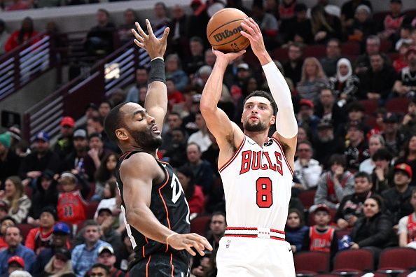 CHICAGO, ILLINOIS - NOVEMBER 12: Zach LaVine #8 of the Chicago Bulls shoots a three point basket in the first half Alec Burks #14 of the Detroit Pistons at the United Center on November 12, 2023 in Chicago, Illinois.  NOTE TO USER: User expressly acknowledges and agrees that, by downloading and or using this photograph, User is consenting to the terms and conditions of the Getty Images License Agreement.  (Photo by Quinn Harris/Getty Images)