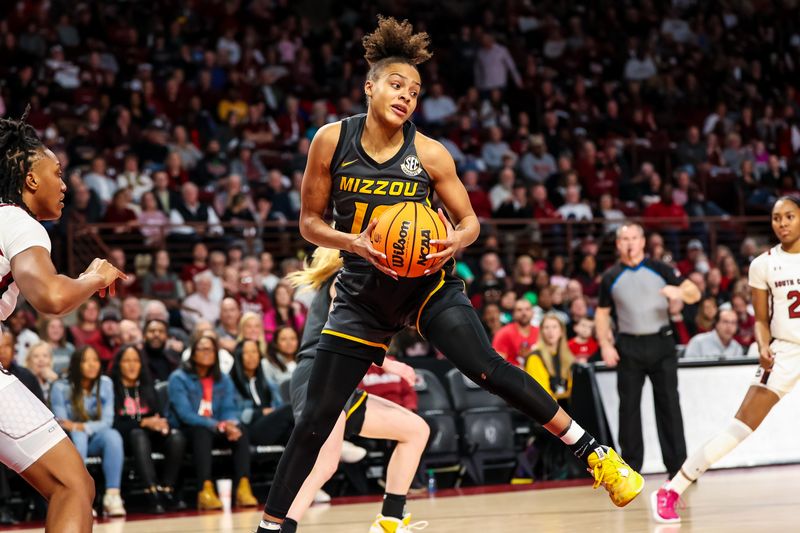 Jan 15, 2023; Columbia, South Carolina, USA; Missouri Tigers guard Katlyn Gilbert (10) grabs a rebound against the South Carolina Gamecocks in the first half at Colonial Life Arena. Mandatory Credit: Jeff Blake-USA TODAY Sports