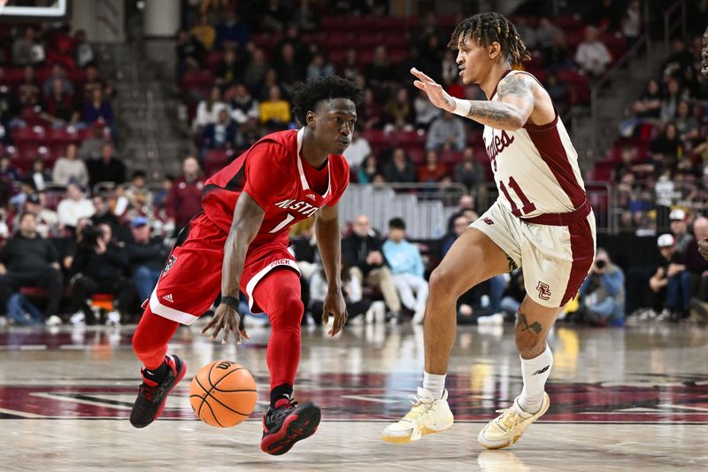 Feb 11, 2023; Chestnut Hill, Massachusetts, USA; North Carolina State Wolfpack guard Jarkel Joiner (1) dribbles the ball around Boston College Eagles guard Makai Ashton-Langford (11) during the second half at the Conte Forum. Mandatory Credit: Brian Fluharty-USA TODAY Sports