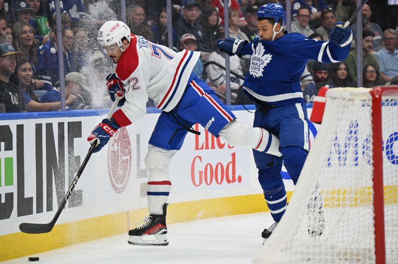 Sep 26, 2024; Toronto, Ontario, CAN;  Montreal Canadiens defenseman Arber Xhekaj (72) and Toronto Maple Leafs forward Ryan Reaves (75) battle for the puck in the first period at Scotiabank Arena. Mandatory Credit: Dan Hamilton-Imagn Images