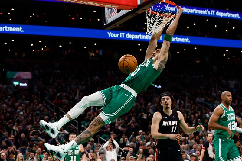 BOSTON, MA - APRIL 24: Jayson Tatum #0 of the Boston Celtics dunks the ball as Jaime Jaquez Jr. #11 of the Miami Heat looks on during the third quarter of game two of the Eastern Conference First Round Playoffs at TD Garden on April 24, 2024 in Boston, Massachusetts. NOTE TO USER: User expressly acknowledges and agrees that, by downloading and/or using this Photograph, user is consenting to the terms and conditions of the Getty Images License Agreement. (Photo By Winslow Townson/Getty Images)