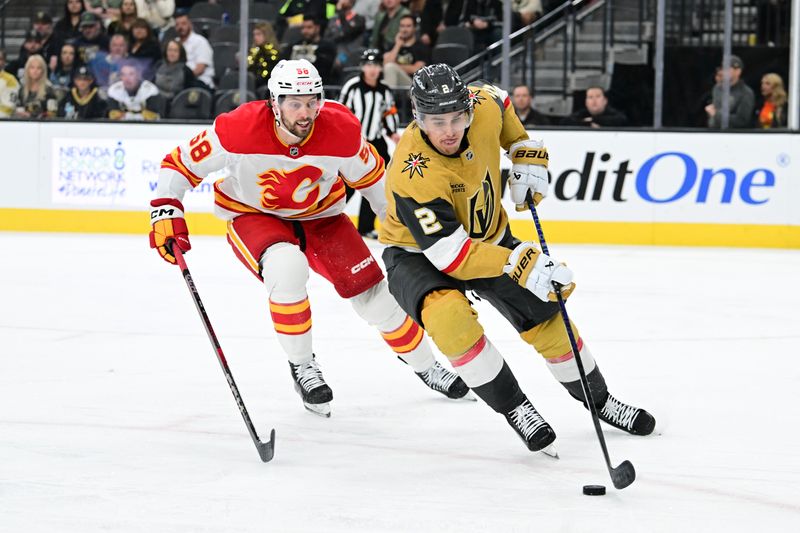 Oct 28, 2024; Las Vegas, Nevada, USA;  Calgary Flames center Justin Kirkland (58) chases after Vegas Golden Knights defenseman Zach Whitecloud (2) in the third period at T-Mobile Arena. Mandatory Credit: Candice Ward-Imagn Images