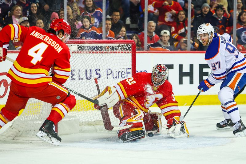 Dec 27, 2025; Calgary, Alberta, CAN; Calgary Flames goaltender Dustin Wolf (32) makes a save against Edmonton Oilers center Connor McDavid (97) during the first period at Scotiabank Saddledome. Mandatory Credit: Sergei Belski-Imagn Images