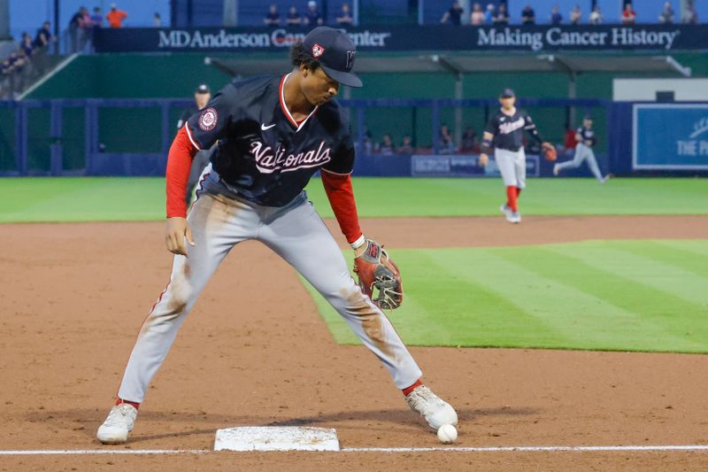 Mar 18, 2024; West Palm Beach, Florida, USA;  Washington Nationals third baseman Trey Lipscomb (38) waits for a slow rolling ball to go foul but it does not for an infield hit by the Houston Astros during the fifth inning at The Ballpark of the Palm Beaches. Mandatory Credit: Reinhold Matay-USA TODAY Sports