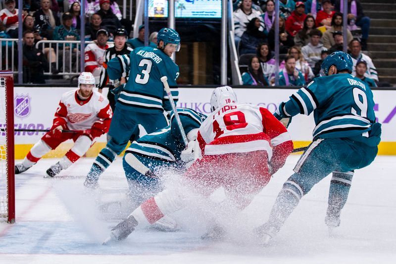Nov 2, 2025; San Jose, California, USA;  San Jose Sharks goaltender Alex Nedeljkovic (33) deflects a shot by Detroit Red Wings center Andrew Copp (18) during the second period at SAP Center at San Jose. Mandatory Credit: John Hefti-Imagn Images