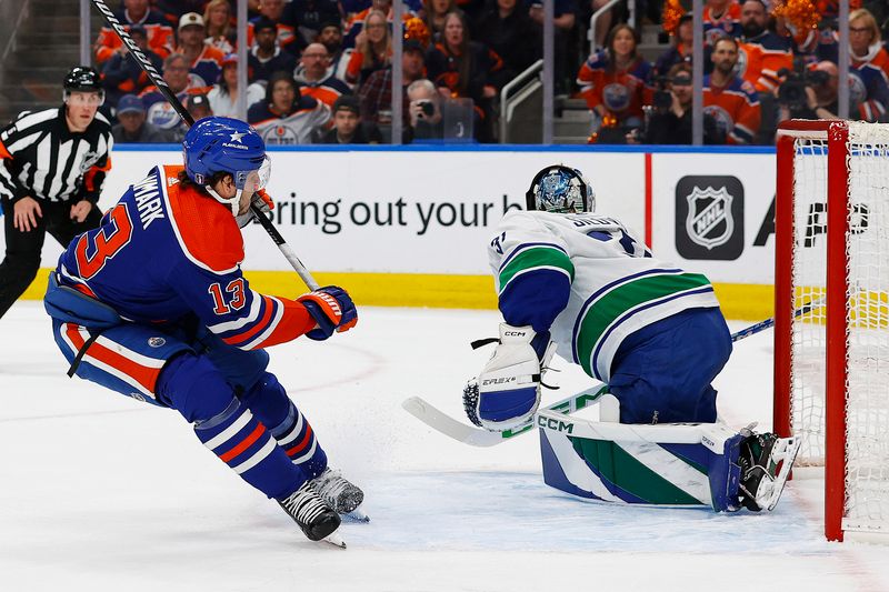 May 14, 2024; Edmonton, Alberta, CAN; Vancouver Canucks goaltender Arturs Silovs (31) makes a save on  on Edmonton Oilers forward Mattias Janmark (13) during the first period in game four of the second round of the 2024 Stanley Cup Playoffs at Rogers Place. Mandatory Credit: Perry Nelson-USA TODAY Sports