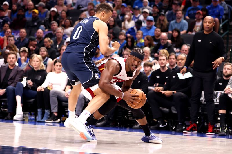 DALLAS, TEXAS - MARCH 07: Jimmy Butler #22 of the Miami Heat is guarded by Dante Exum #0 of the Dallas Mavericks in the first half at American Airlines Center on March 07, 2024 in Dallas, Texas.  NOTE TO USER: User expressly acknowledges and agrees that, by downloading and or using this photograph, User is consenting to the terms and conditions of the Getty Images License Agreement. (Photo by Tim Heitman/Getty Images)