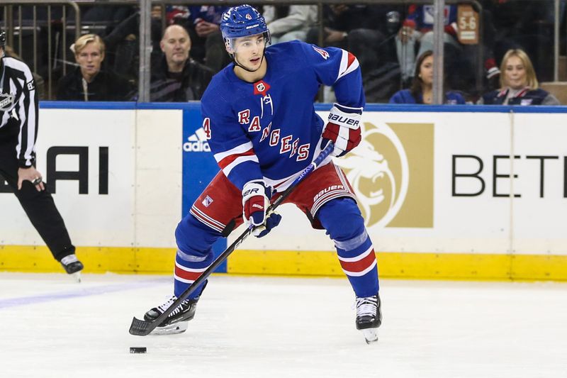 Nov 12, 2023; New York, New York, USA; New York Rangers defenseman Braden Schneider (4) looks to pass in the first period against the Columbus Blue Jackets at Madison Square Garden. Mandatory Credit: Wendell Cruz-USA TODAY Sports