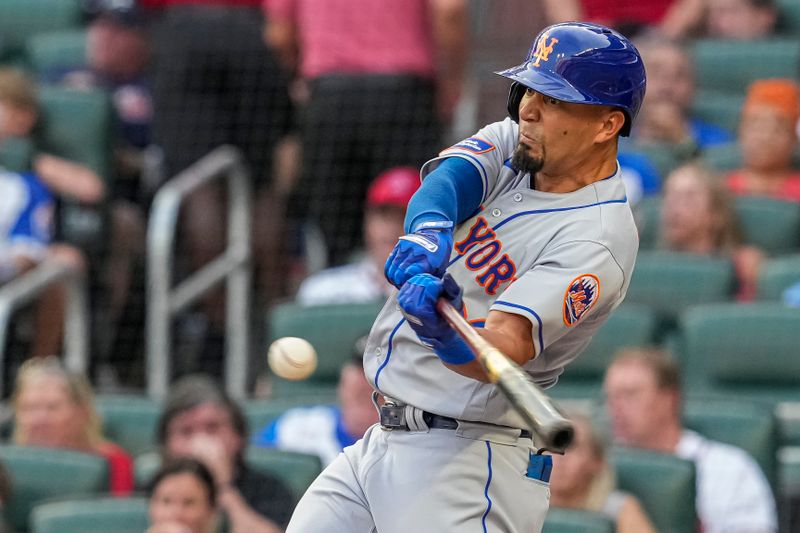 Aug 21, 2023; Cumberland, Georgia, USA; New York Mets center fielder Rafael Ortega (30) hits a two run home run against the Atlanta Braves during the second inning at Truist Park. Mandatory Credit: Dale Zanine-USA TODAY Sports