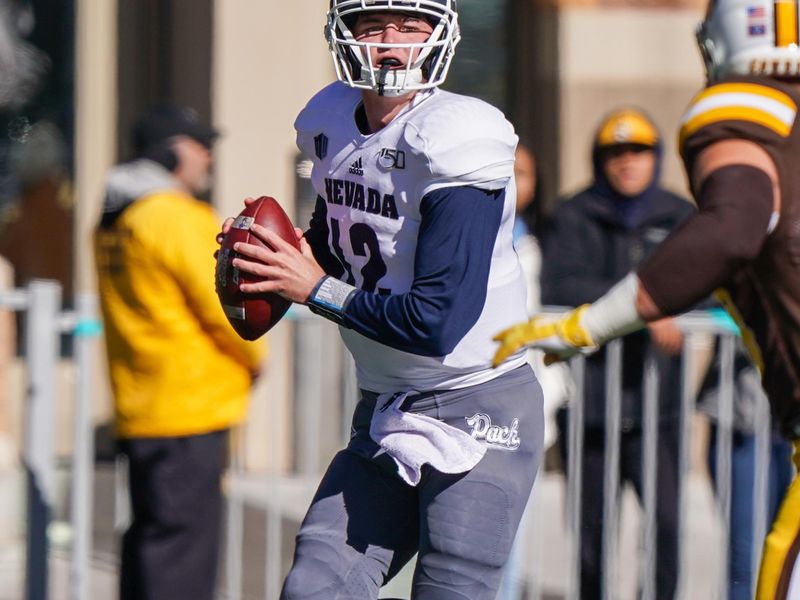 Oct 26, 2019; Laramie, WY, USA; Nevada Wolf Pack quarterback Carson Strong (12) looks to throw against the Wyoming Cowboys during the first quarter at Jonah Field War Memorial Stadium. Mandatory Credit: Troy Babbitt-USA TODAY Sports