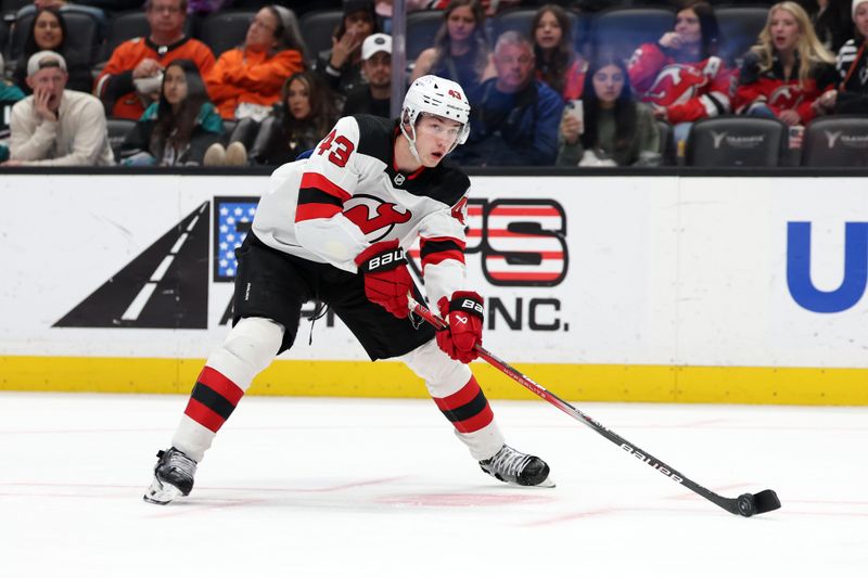 Mar 1, 2024; Anaheim, California, USA; New Jersey Devils defenseman Luke Hughes (43) controls the puck during the third period against the Anaheim Ducks at Honda Center. Mandatory Credit: Kiyoshi Mio-USA TODAY Sports