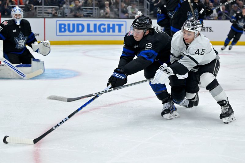Jan 2, 2024; Los Angeles, California, USA; Toronto Maple Leafs defenseman Simon Benoit (2) and Los Angeles Kings center Blake Lizotte (46) go for the puck in the second period at Crypto.com Arena. Mandatory Credit: Jayne Kamin-Oncea-USA TODAY Sports