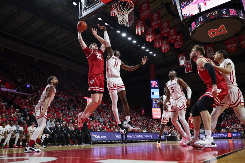 Feb 10, 2024; Piscataway, New Jersey, USA; Wisconsin Badgers forward Steven Crowl (22) drives to the basket against Rutgers Scarlet Knights center Clifford Omoruyi (11) during the first half at Jersey Mike's Arena. Mandatory Credit: Vincent Carchietta-USA TODAY Sports