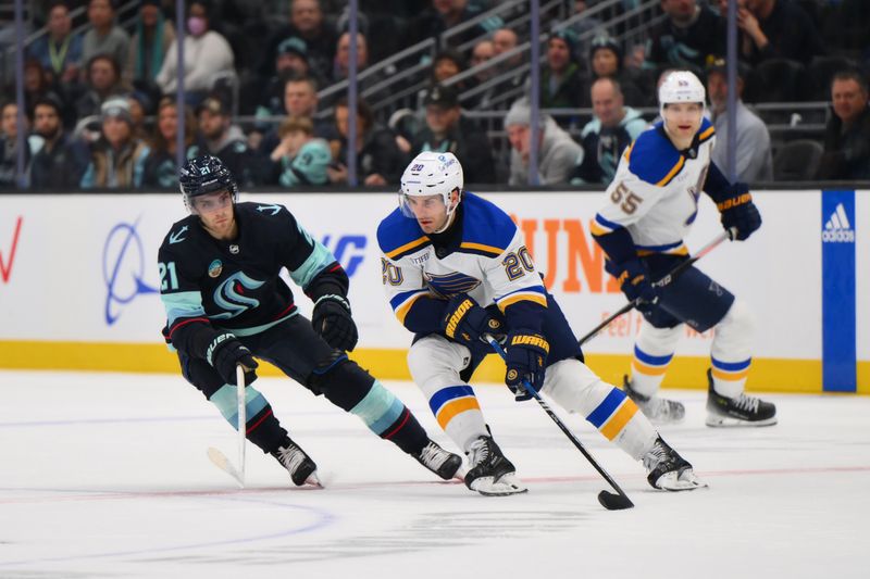 Jan 26, 2024; Seattle, Washington, USA; St. Louis Blues left wing Brandon Saad (20) plays the puck while defended by Seattle Kraken center Alex Wennberg (21) during overtime at Climate Pledge Arena. Mandatory Credit: Steven Bisig-USA TODAY Sports