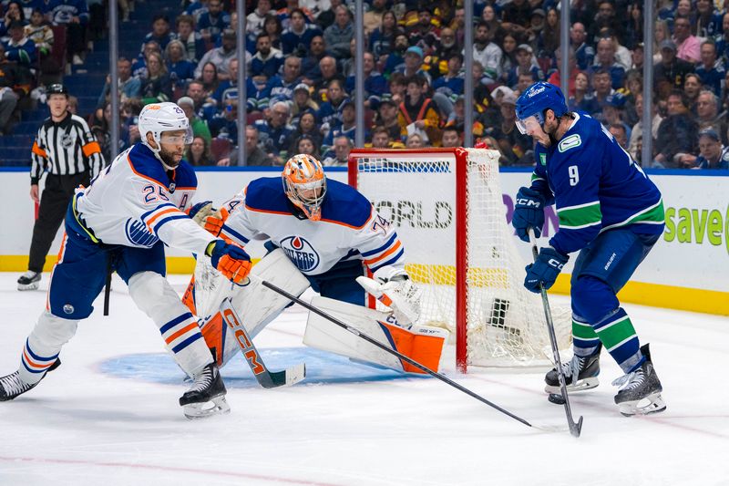 May 8, 2024; Vancouver, British Columbia, CAN; Edmonton Oilers defenseman Darnell Nurse (25) and goalie Stuart Skinner (74) watch as Vancouver Canucks forward J.T. Miller (9) redirects a shot past Skinner during the third period in game one of the second round of the 2024 Stanley Cup Playoffs at Rogers Arena. Mandatory Credit: Bob Frid-USA TODAY Sports