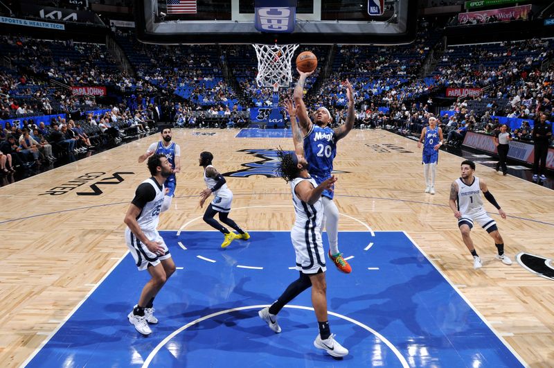 ORLANDO, FL - MARCH 30: Markelle Fultz #20 of the Orlando Magic drives to the basket during the game against the Memphis Grizzlies on March 30, 2024 at the Kia Center in Orlando, Florida. NOTE TO USER: User expressly acknowledges and agrees that, by downloading and or using this photograph, User is consenting to the terms and conditions of the Getty Images License Agreement. Mandatory Copyright Notice: Copyright 2024 NBAE (Photo by Fernando Medina/NBAE via Getty Images)