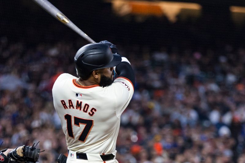 May 15, 2024; San Francisco, California, USA; San Francisco Giants left fielder Heliot Ramos (17) hits an RBI double against the Los Angeles Dodgers during the sixth inning at Oracle Park. Mandatory Credit: John Hefti-USA TODAY Sports