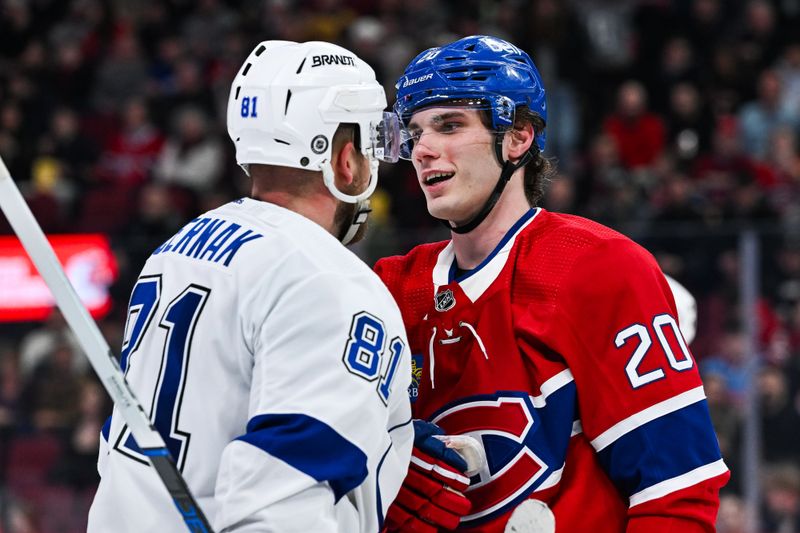 Apr 4, 2024; Montreal, Quebec, CAN; Montreal Canadiens left wing Juraj Slafkovsky (20) has a discussion with Tampa Bay Lightning defenseman Erik Cernak (81) during the second period at Bell Centre. Mandatory Credit: David Kirouac-USA TODAY Sports