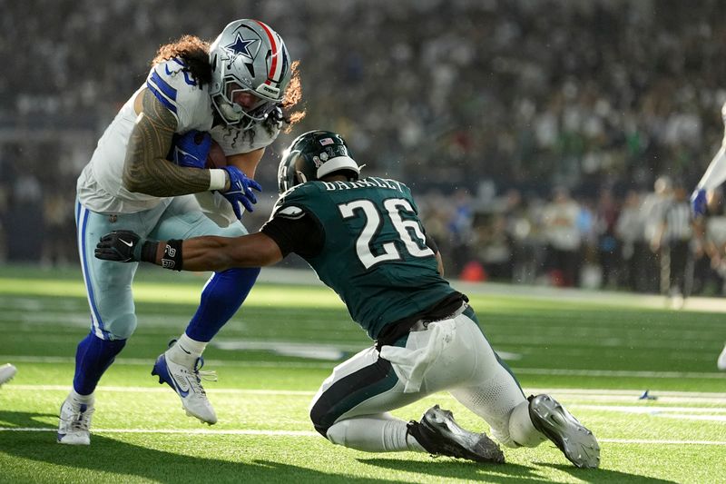 Dallas Cowboys linebacker Marist Liufau (35) is stopped by Philadelphia Eagles running back Saquon Barkley (26) after Liufau recovere an Eagles fumble in the first half of an NFL football game in Arlington, Texas, Sunday, Nov. 10, 2024. (AP Photo/Julio Cortez)