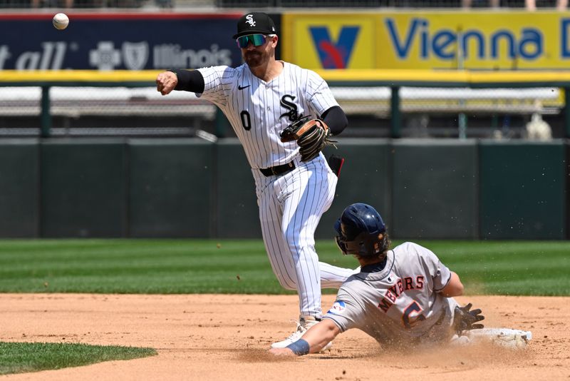 Jun 20, 2024; Chicago, Illinois, USA;  Chicago White Sox second baseman Danny Mendick (0)  throws for a double play after forcing Houston Astros outfielder Jake Meyers (6) out during the second inning at Guaranteed Rate Field. Mandatory Credit: Matt Marton-USA TODAY Sports