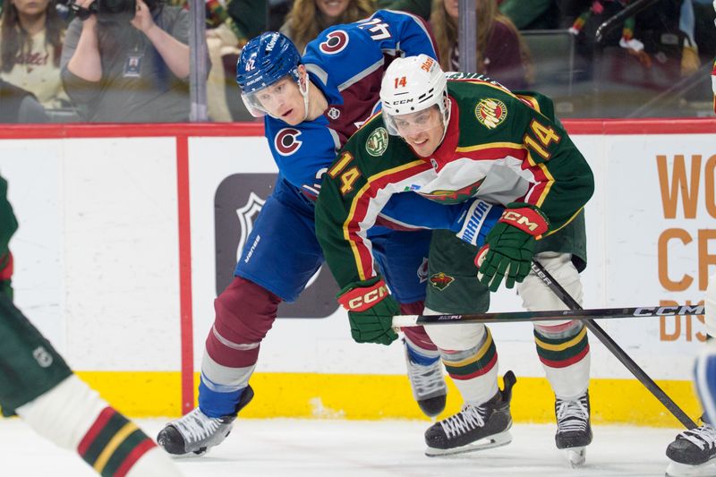 Dec 21, 2025; Saint Paul, Minnesota, USA; Colorado Avalanche defenseman Josh Manson (42) ties up Minnesota Wild center Joel Eriksson Ek (14) in the third period at Grand Casino Arena. Mandatory Credit: Matt Blewett-Imagn Images