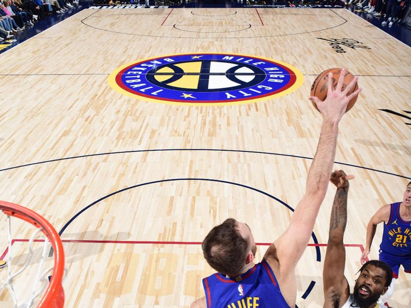 DENVER, CO - JANUARY 12: Jay Huff #30 of the Denver Nuggets blocks a shot during the game against the New Orleans Pelicans on January 12, 2024 at the Ball Arena in Denver, Colorado. NOTE TO USER: User expressly acknowledges and agrees that, by downloading and/or using this Photograph, user is consenting to the terms and conditions of the Getty Images License Agreement. Mandatory Copyright Notice: Copyright 2024 NBAE (Photo by Garrett Ellwood/NBAE via Getty Images)